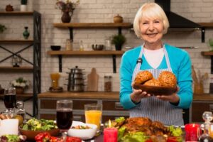 elderly-woman-holding-plate-with-bread-looking-camera_23-2148314886