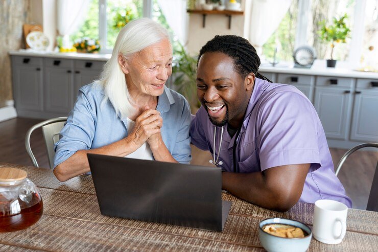 social-worker-looking-laptop-with-senior-woman_23-2149031357